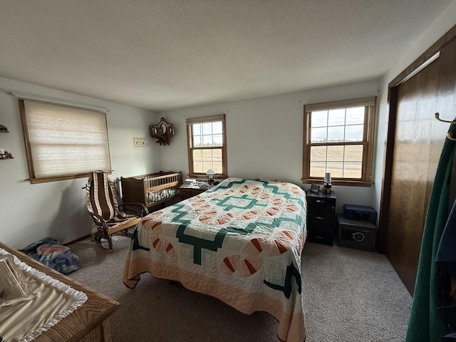 carpeted bedroom featuring a textured ceiling