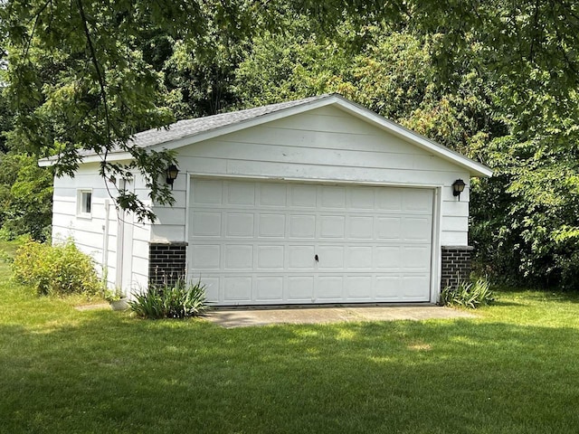 garage featuring a lawn