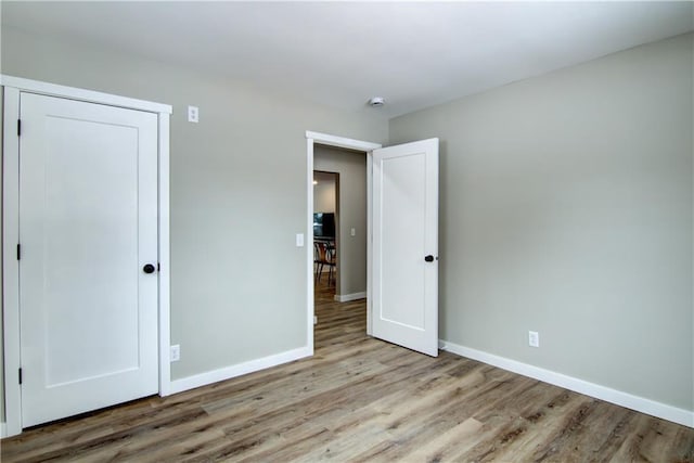 unfurnished bedroom featuring light wood-type flooring