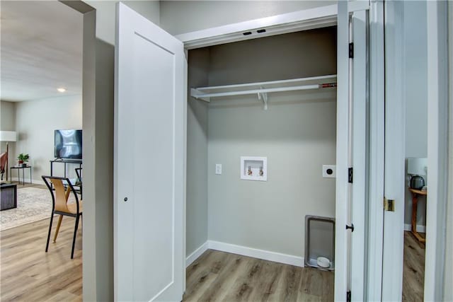 laundry room with hookup for an electric dryer, hookup for a washing machine, and light wood-type flooring