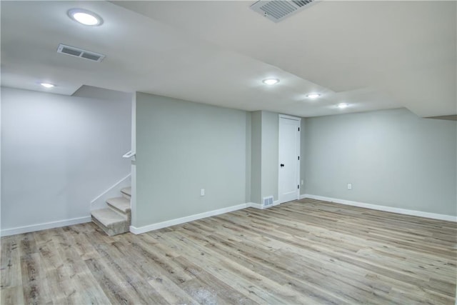 basement with light hardwood / wood-style floors