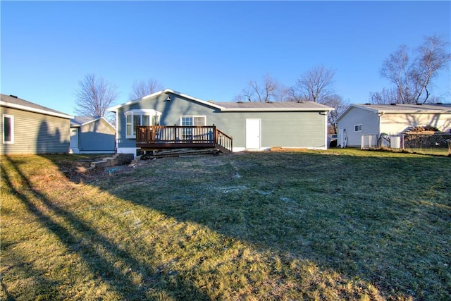 back of house with a wooden deck and a yard