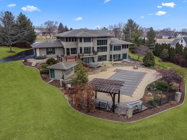 back of property with a balcony, a yard, a patio area, and a pergola