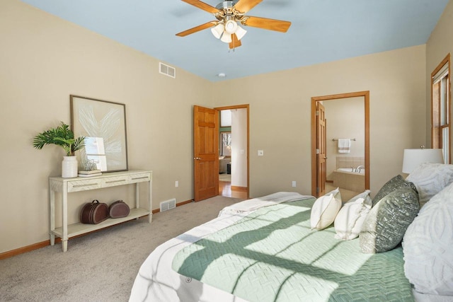 carpeted bedroom with ensuite bathroom and ceiling fan