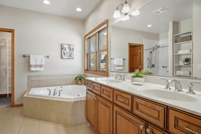 bathroom featuring tile patterned floors, plus walk in shower, and vanity