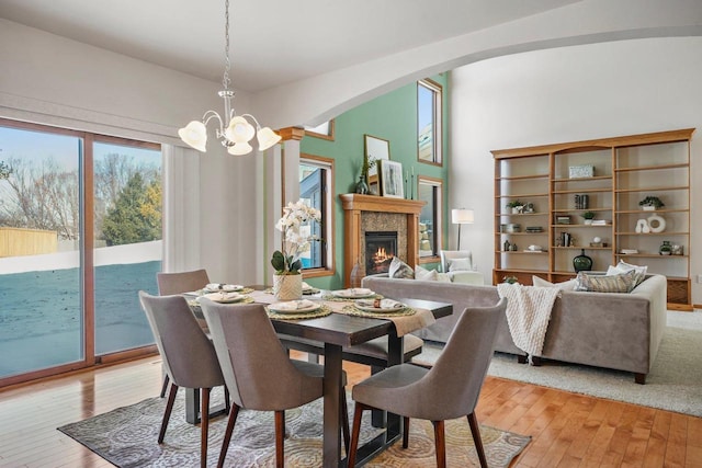 dining room with light hardwood / wood-style floors and a notable chandelier