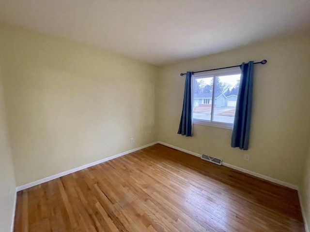 spare room featuring hardwood / wood-style floors