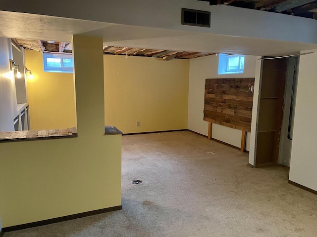 basement featuring light colored carpet