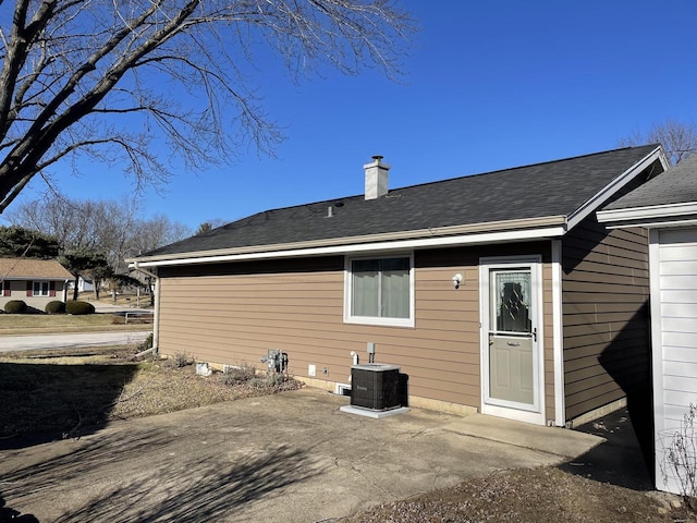 rear view of property with central AC unit and a patio area