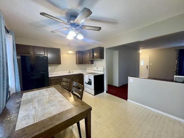 kitchen featuring black fridge, sink, dark brown cabinets, and white range with electric cooktop