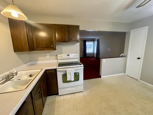 kitchen featuring white electric stove, decorative light fixtures, sink, and dark brown cabinets