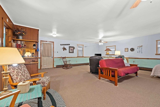 carpeted living room featuring ceiling fan and baseboard heating