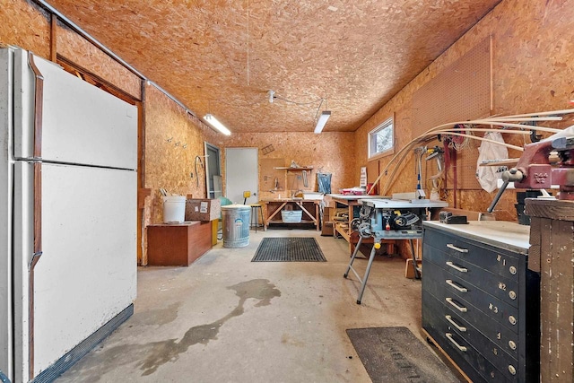 misc room with concrete flooring and a workshop area