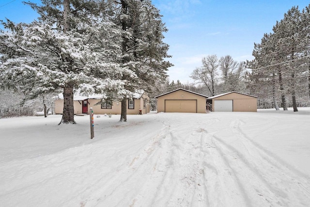 view of front of property featuring a garage and an outbuilding