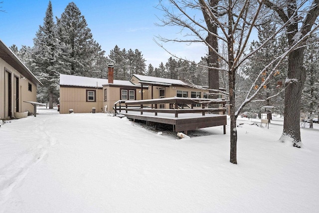 yard covered in snow with a deck