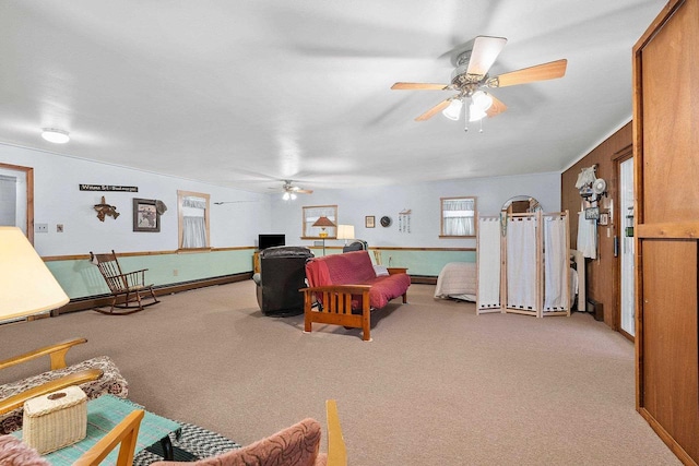 living room with ceiling fan and light colored carpet