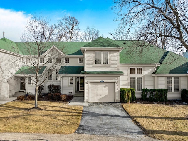 view of property featuring a garage and a front yard