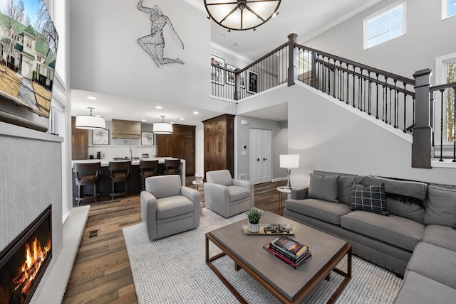 living room with crown molding and hardwood / wood-style flooring