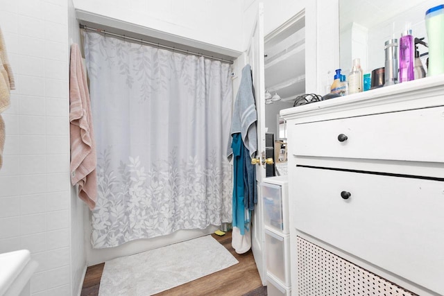 bathroom featuring a shower with shower curtain and hardwood / wood-style floors