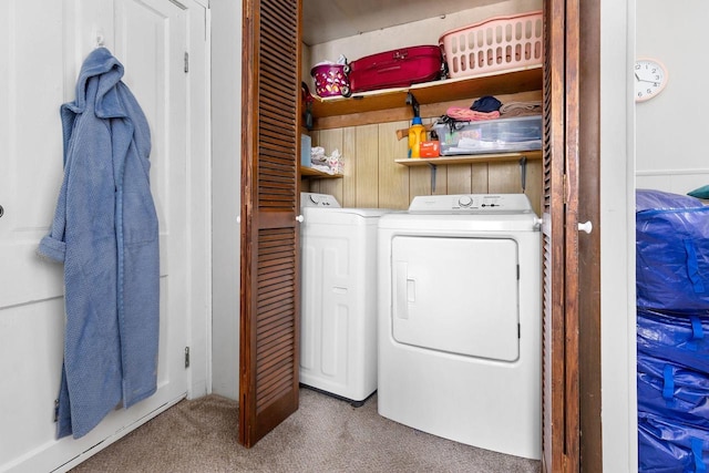 washroom with washing machine and clothes dryer and carpet