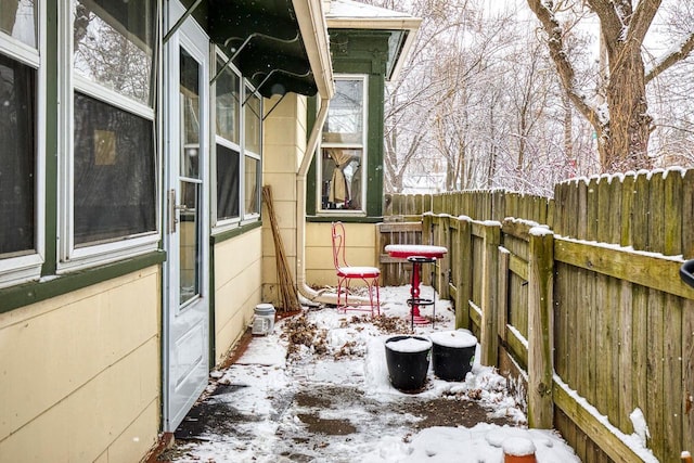 view of snow covered back of property