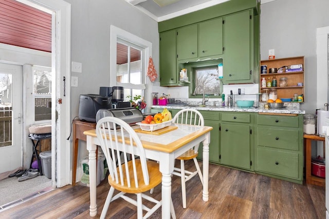 kitchen with dark wood-type flooring, sink, and green cabinets