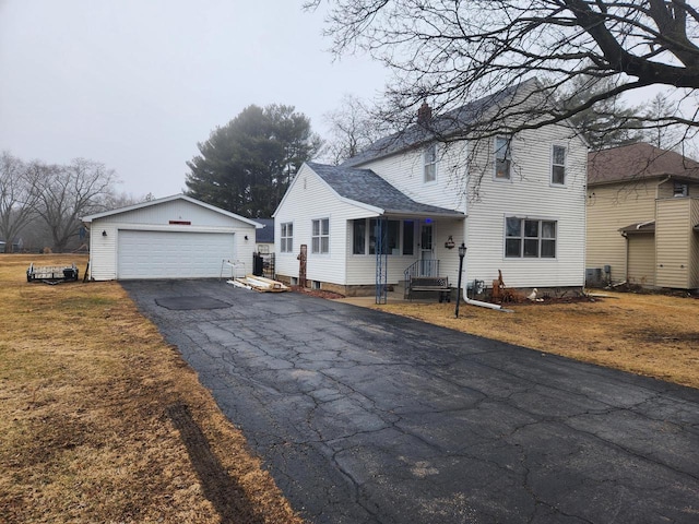 view of front of house featuring an outbuilding, cooling unit, and a garage