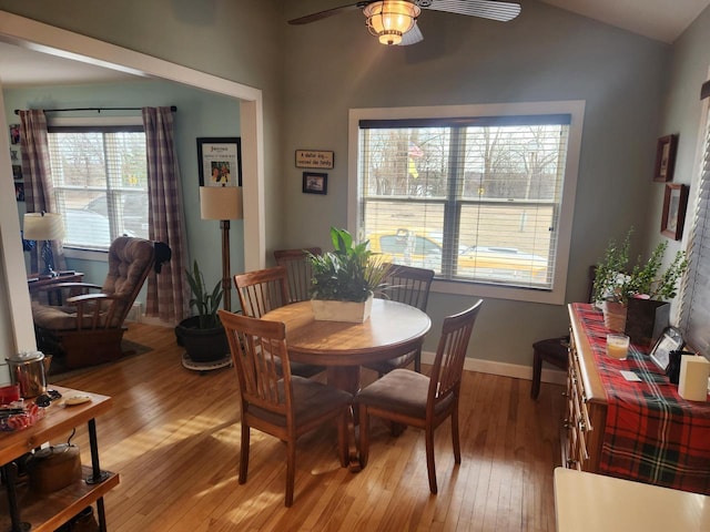 dining space with vaulted ceiling, ceiling fan, and light hardwood / wood-style floors