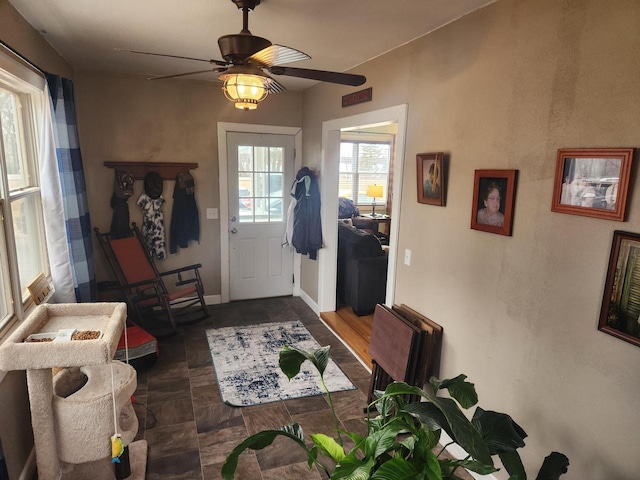 foyer entrance with ceiling fan