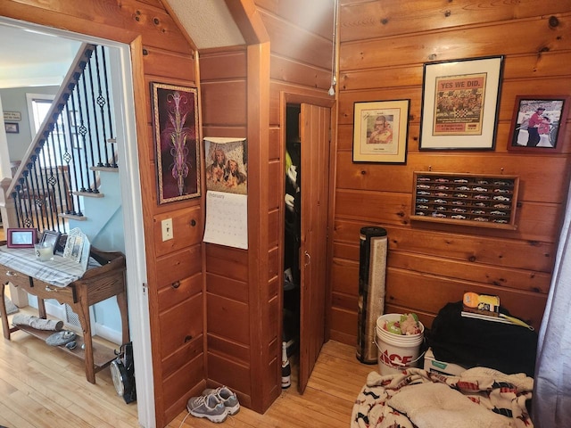 interior space featuring light hardwood / wood-style flooring and wood walls