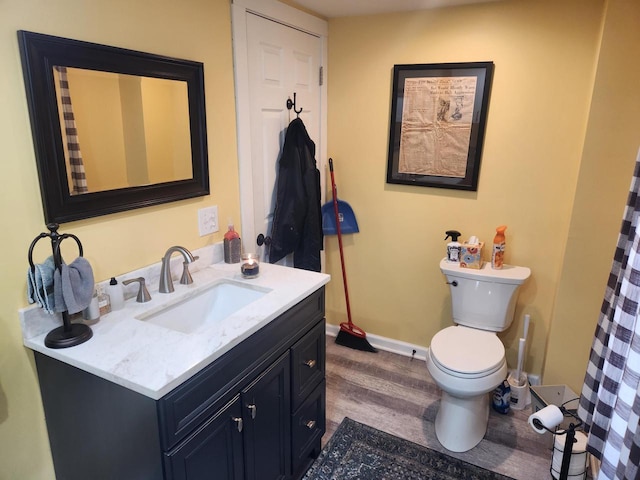 bathroom with vanity, wood-type flooring, and toilet