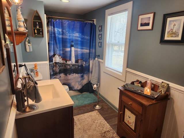 bathroom with vanity, wood-type flooring, and walk in shower