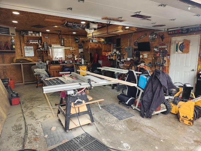 garage featuring a garage door opener and a workshop area