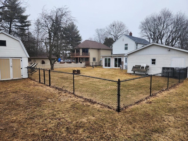 back of property with a storage unit and a lawn