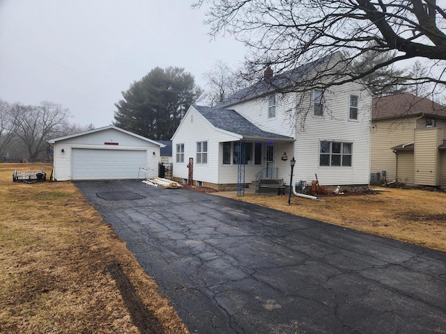 view of front facade featuring a garage and an outbuilding