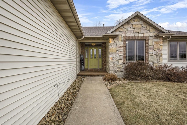 doorway to property featuring a lawn