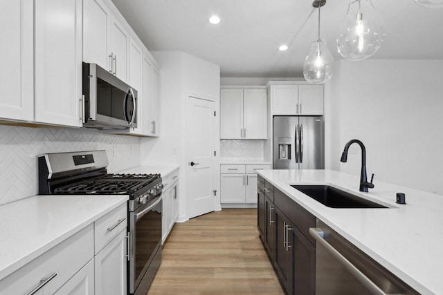 kitchen with white cabinetry, appliances with stainless steel finishes, and sink