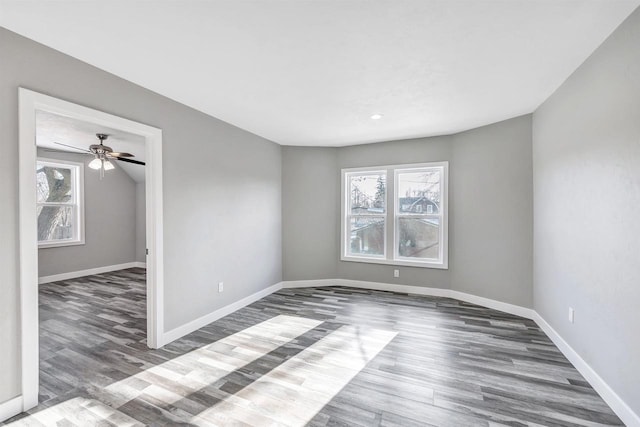 unfurnished room featuring ceiling fan and dark hardwood / wood-style flooring