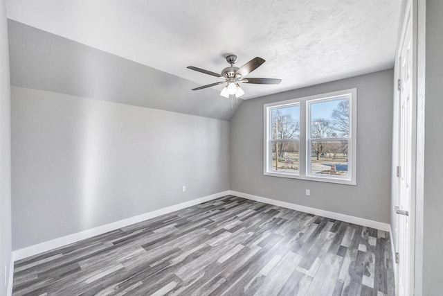 bonus room with hardwood / wood-style flooring, ceiling fan, lofted ceiling, and a textured ceiling