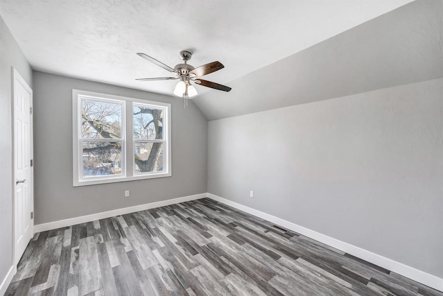 bonus room with ceiling fan, dark hardwood / wood-style floors, and vaulted ceiling