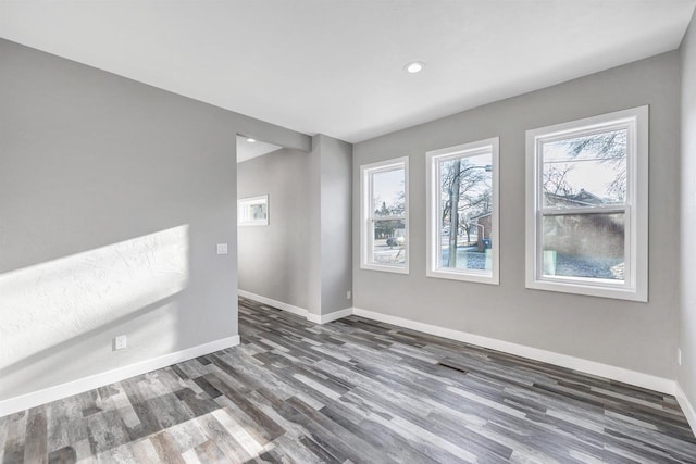 unfurnished room with dark wood-type flooring