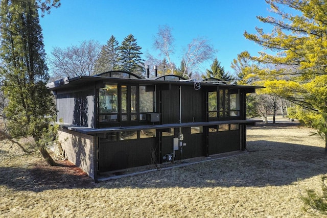 back of property featuring a sunroom