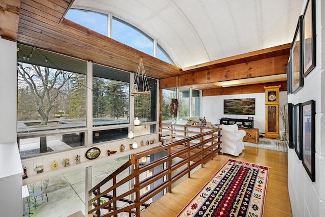 sunroom / solarium featuring lofted ceiling and plenty of natural light