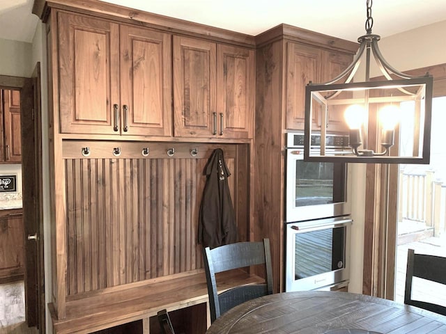 mudroom featuring a chandelier
