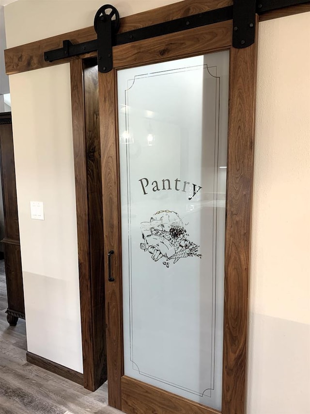 interior details with hardwood / wood-style flooring and a barn door