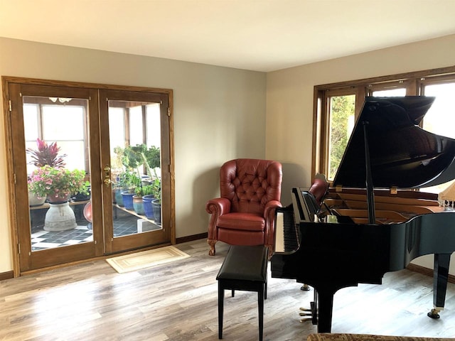 sitting room featuring light hardwood / wood-style floors and french doors