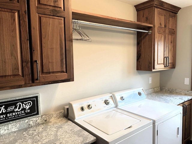 washroom with washing machine and dryer and cabinets