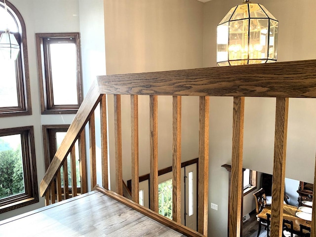 stairs featuring a chandelier
