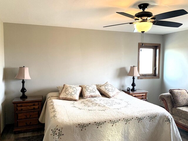 bedroom with ceiling fan and dark hardwood / wood-style floors