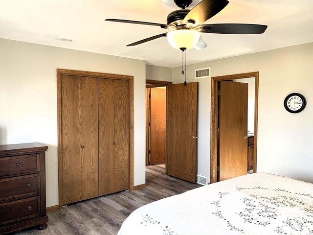 bedroom featuring dark hardwood / wood-style flooring, a closet, and ceiling fan